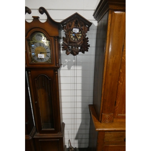 2924 - An ornate heavily carved cuckoo clock with fir cone weights