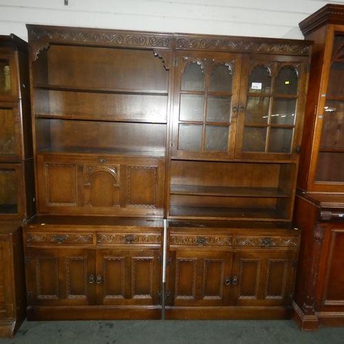 2930 - 2 reproduction carved oak floor standing units each with shelves, drawers and panel doors, approx 92... 