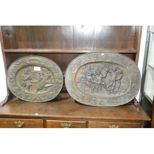 2935 - 2 antique decorative heavily embossed brass relief oval wall plates. The larger is approx 72 x 53cm ... 