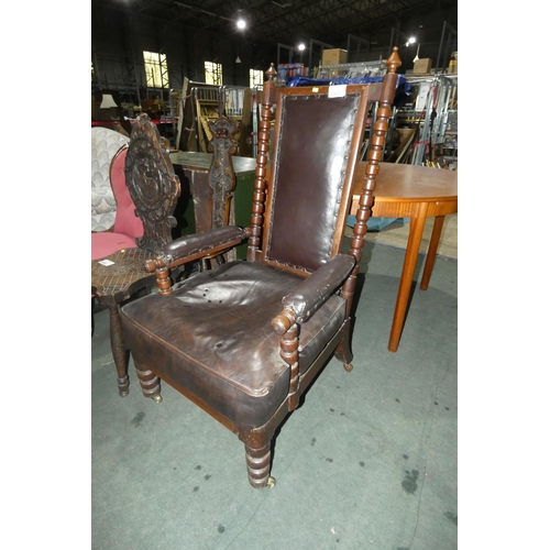 2963 - A large Edwardian Oak gentleman's elbow chair with brown upholstery