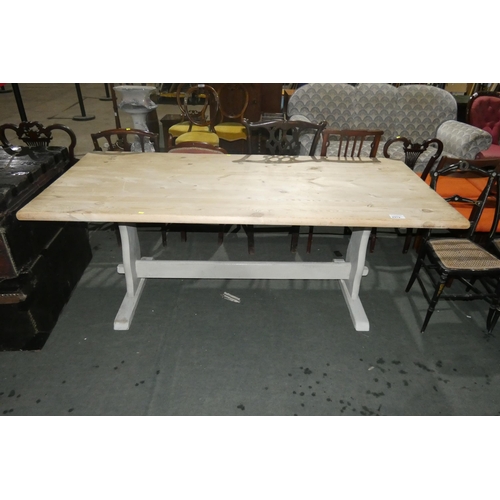 2979 - A large rectangular deal top farmhouse refectory table with trestle supports, approximately 197 cm l... 