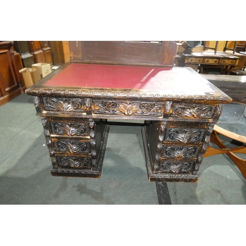 3006 - An early 20th century heavily carved oak twin pedestal desk with a tooled leather top, 1 central and... 