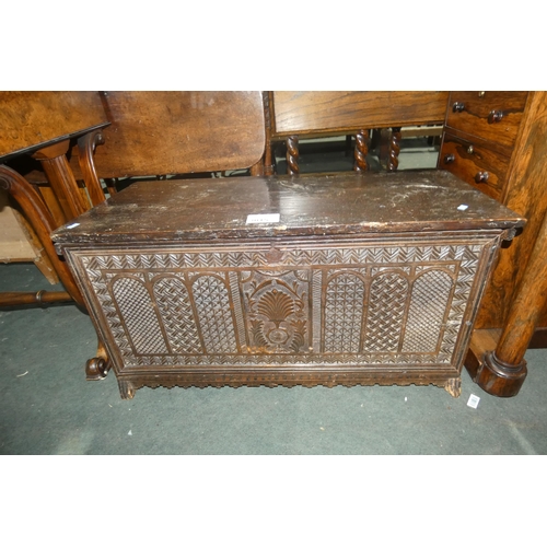 3015 - A small heavily carved oak storage chest with a lift lid, approximately 90 cm wide