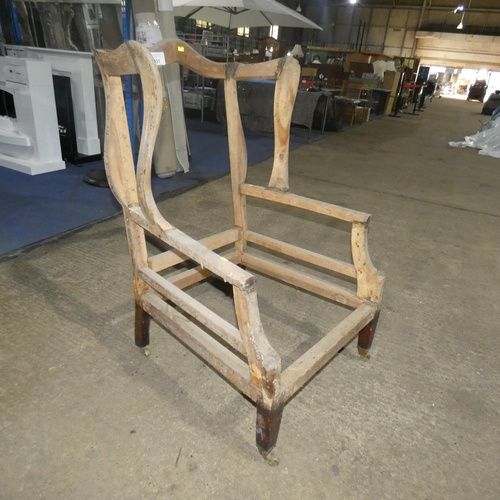 3031 - A large winged armchair frame for reupholstery