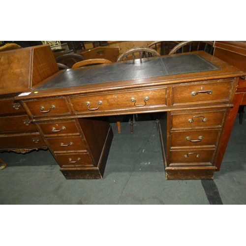 3041 - A reproduction Oak rectangular topped pedestal writing desk with a tooled leather surface, one centr... 