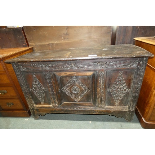 3050 - An early Oak coffer with a panelled front and lift lid, approximately 123 cm wide