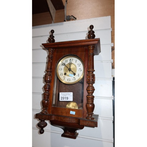 2919 - A small mahogany case wall clock with a glass door