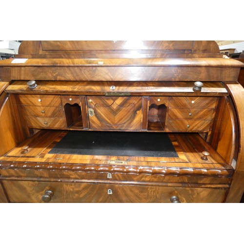 3066 - A fine harewood and mahogany cylinder front Bureau with a fitted interior with secret drawers and co... 