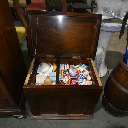 2958 - A floor standing mahogany sewing box with a lift lid and fitted interior