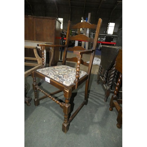 3025 - A dark wood ladder back elbow chair with a tapestry seat