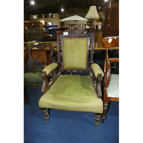 3181 - An Edwardian carved mahogany gentleman's armchair with green upholstery