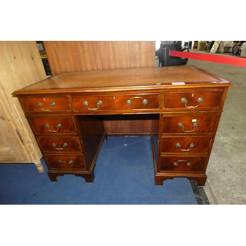 3189 - A reproduction mahogany rectangular top pedestal desk with a tooled leather surface one central and ... 