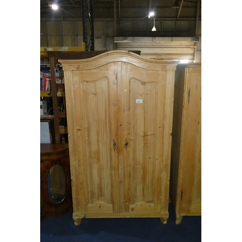 3192 - A pine wardrobe with two panel doors enclosing hanging space and drawer, approximately 117cm wide