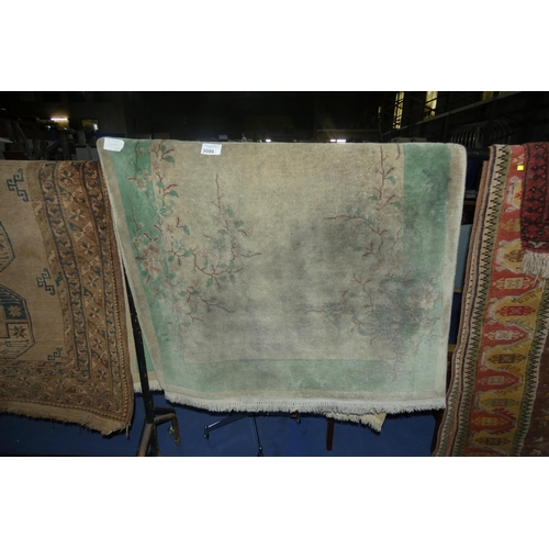 3086 - A green ground floral patterned Chinese rug approximately 210 cm by 120cm