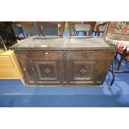 3089 - A carved oak coffer with a lift lid, approximately 114 cm wide