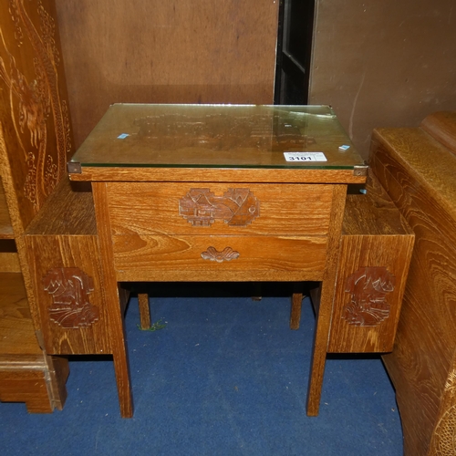 3101 - A heavily carved oriental hardwood sewing table with a lift lid and drawer