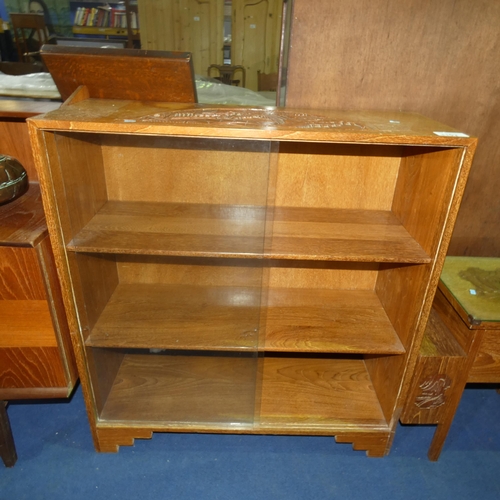 3102 - A Heavily carved oriental hardwood bookcase with glass sliding doors, approximately 91 cm wide