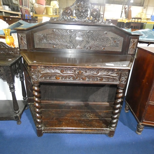 3117 - A heavily carved dark oak hall table with one drawer and an open shelf on twisted legs, approximatel... 