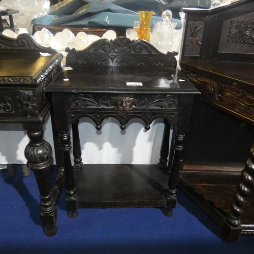 3118 - A heavily carved dark hall table with one drawer and open shelf, approximately 61 cm wide