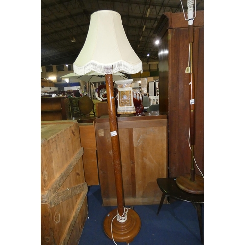 3142 - A heavily carved oriental hardwood lamp standard with shade