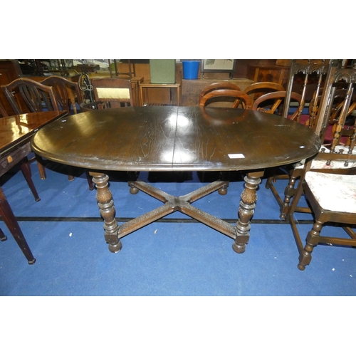 3156 - A reproduction dark wood oval topped extending dining table on turned legs with a fold away centre l... 