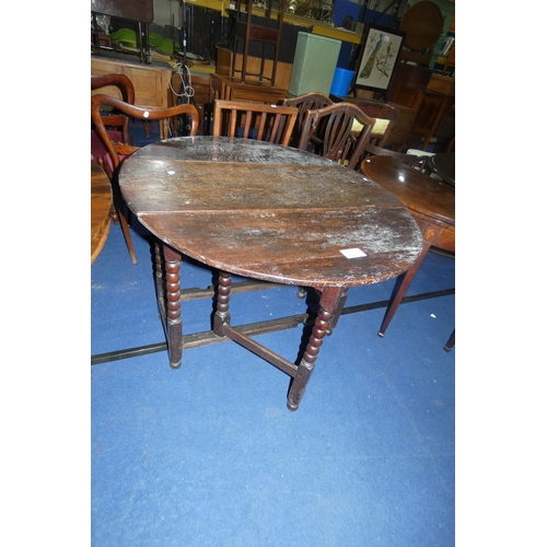 3158 - An early Oak oval topped gateleg table with turned supports