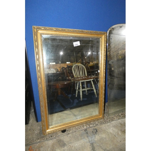 3163 - A Rectangular bevelled wall mirror in an ornate gilt frame