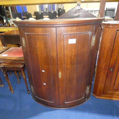 3204 - A nineteenth century Oak bow front wall hanging display cabinet with 2 panel doors