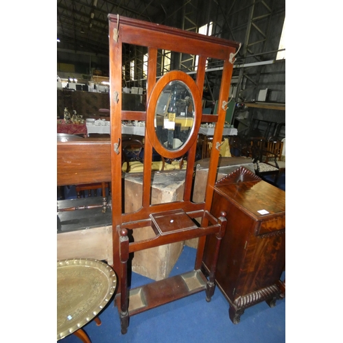 3215 - An Edwardian mahogany hall stand with an oval mirrored back, glove compartment and umbrella compartm... 