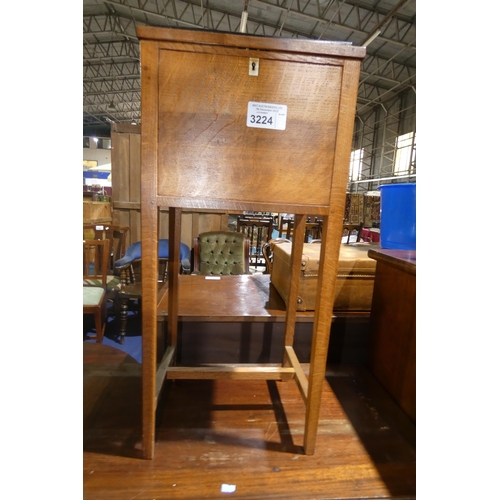 3224 - A small vintage oak floor standing sewing box with a lift lid enclosing lift out trays