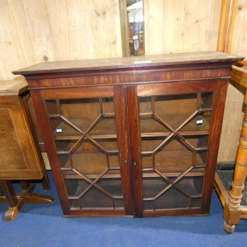 3229 - A reproduction mahogany wall hanging display cabinet with two astral glazed doors, approximately 83 ... 