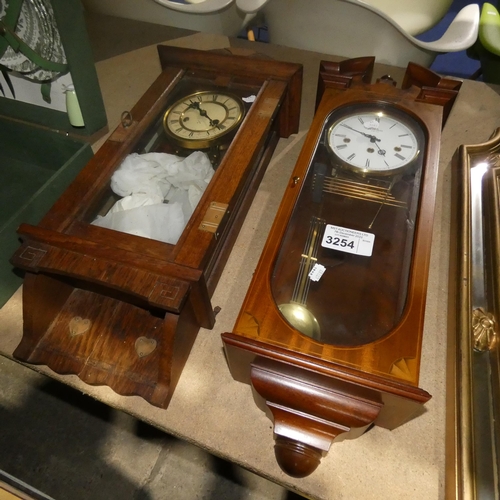 3254 - A Mahogany cased wall clock and an oak cased wall clock