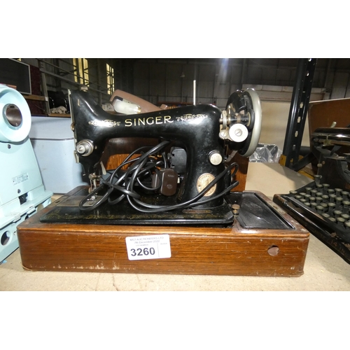 3260 - A vintage Singer electric sewing machine in a wooden carry case