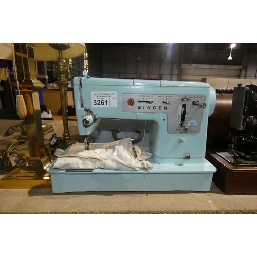 3261 - A vintage blue Singer electric sewing machine in carry case