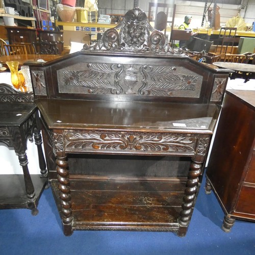 3117 - A heavily carved dark oak hall table with one drawer and an open shelf on twisted legs, approximatel... 