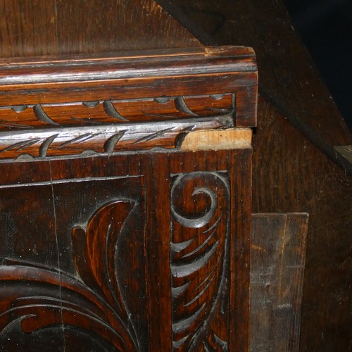 3120 - A heavily carved dark oak Bureau with a fall front enclosing a fitted interior and 3 drawers under, ... 