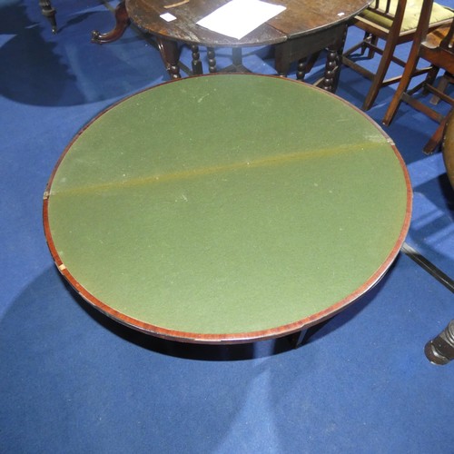 3157 - A 19th Century inlaid mahogany semicircular foldover card table enclosing a green based surface