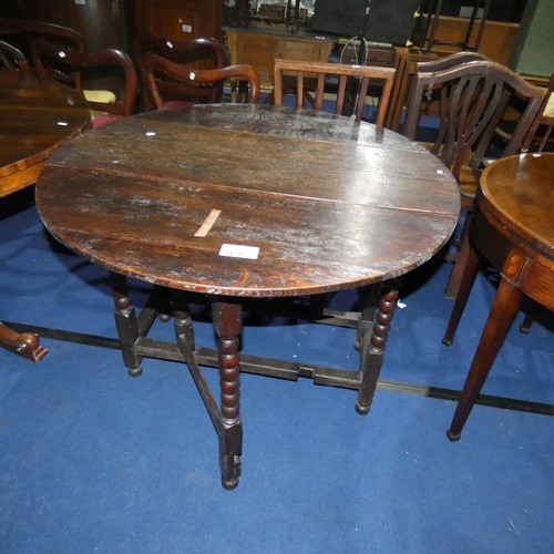 3158 - An early Oak oval topped gateleg table with turned supports