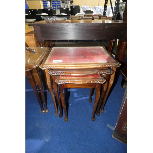 3205 - A nest of three reproduction mahogany coffee tables with tooled leather and glass tops