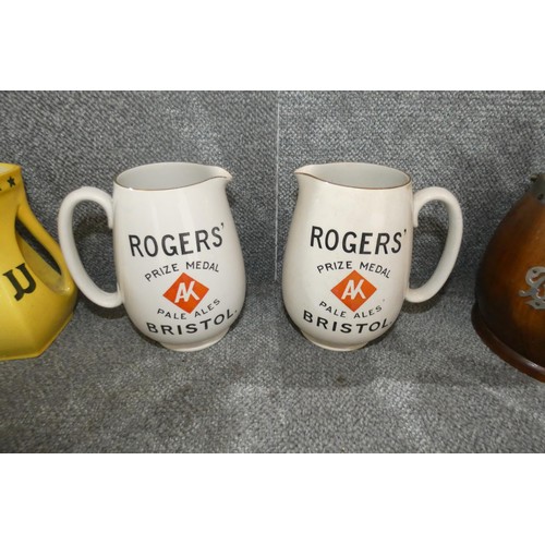 2906 - A quantity of pub related water jugs, ashtrays and two vintage wooden biscuit barrels