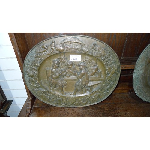 2935 - 2 antique decorative heavily embossed brass relief oval wall plates. The larger is approx 72 x 53cm ... 