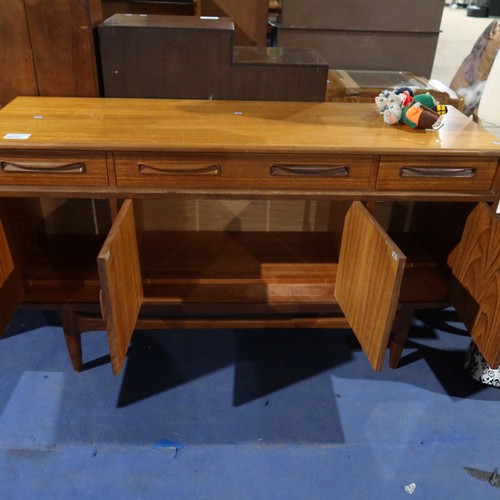 3070 - A 1970s vintage teak sideboard with 3 top drawers and 4 cupboards under, approximately 152cm wide. N... 