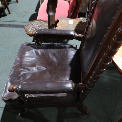 2963 - A large Edwardian Oak gentleman's elbow chair with brown upholstery