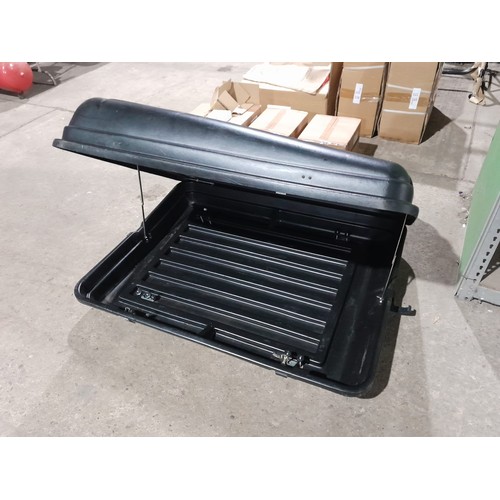 2096 - A black plastic vehicle roof box by Auto Plas approx 130 x 100 x 30cm deep - Four universal mounting... 