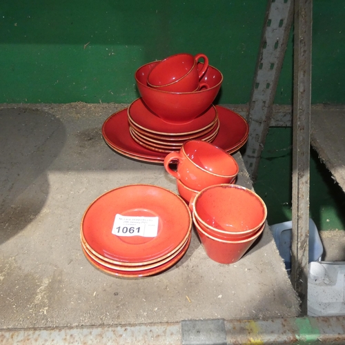 1061 - A quantity of various red stoneware style crockery by Porcelite type Seasons