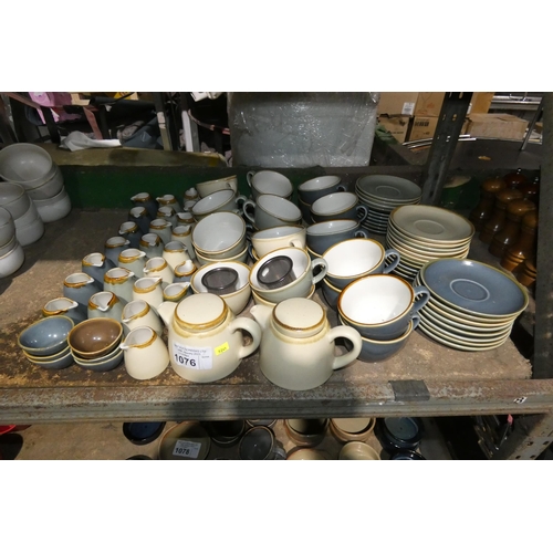 1076 - A large quantity of various stoneware style crockery by Olympia Kiln