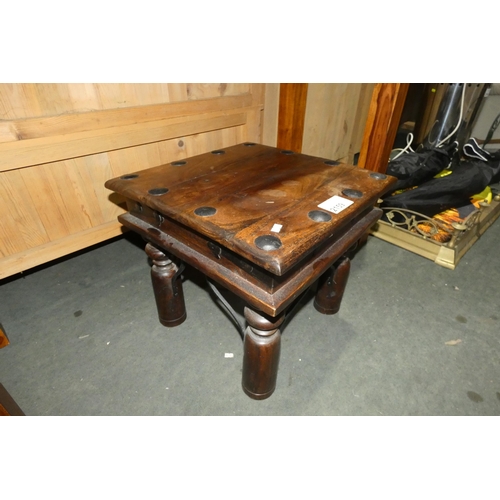 2159 - A dark wood coffee table with metal stud decoration