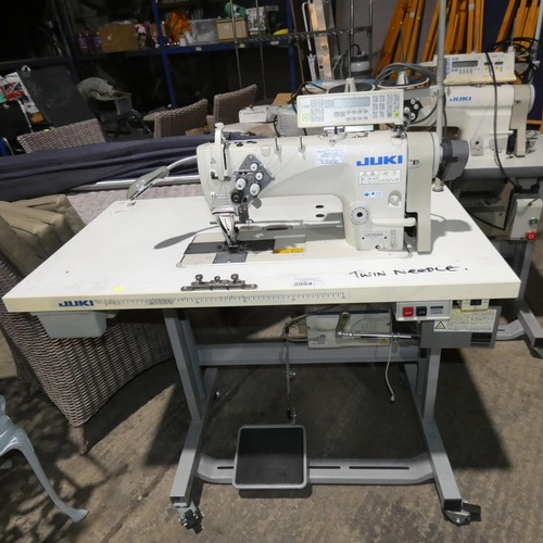 2064 - A Juki LH-3528A industrial twin needle sewing machine 240v fitted with a C-60M control unit, a HVP-9... 