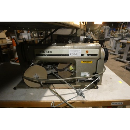 2084 - A Singer 591 industrial sewing machine 240v fitted with a Singer  AS-4002 motor, mounted on an indus... 