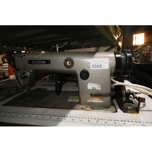 2086 - A Brother DB2-B755-3B industrial sewing machine 240v fitted with a DASEW clutch motor, mounted on an... 